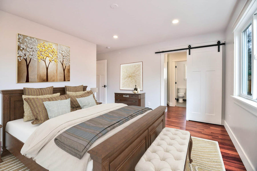 Interior of bedroom featuring bed, nightstand, and painting.